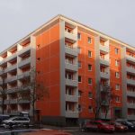 Fassade, orange gestrichen mit grauen Balkonen